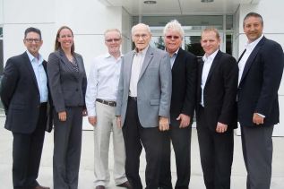  l-r: Al, Harry and Larry Revell pose with representatives from Ford at the official ribbon cutting event at Revell's in Verona on May 28  